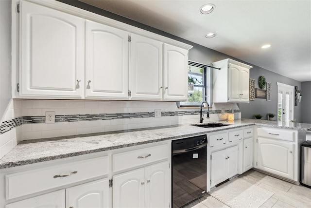 7921 NW 40th St, Bethany, OK 73008 - kitchen with black dishwasher, a sink, white cabinets, recessed lighting, and backsplash