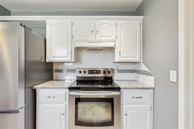 7921 NW 40th St, Bethany, OK 73008 - kitchen with stainless steel appliances, under cabinet range hood, tasteful backsplash, white cabinetry, and light stone countertops