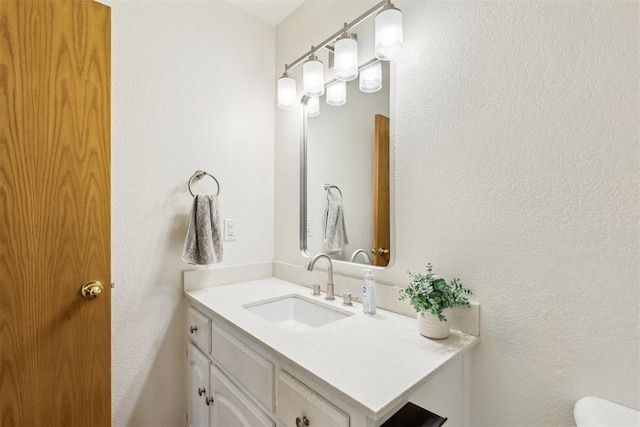 7921 NW 40th St, Bethany, OK 73008 - half bathroom with vanity, a textured wall, and toilet