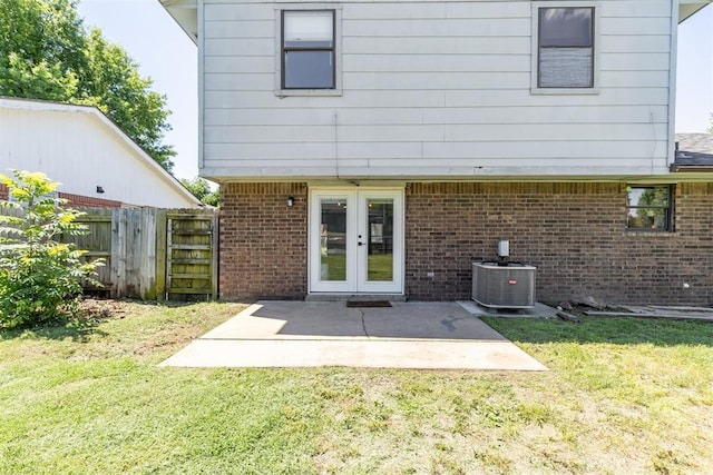 7921 NW 40th St, Bethany, OK 73008 - rear view of property with cooling unit, french doors, brick siding, and a patio area