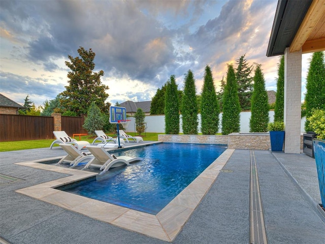 15825 Lacebark Ln, Edmond, OK 73013 - pool at dusk featuring a fenced backyard and a patio