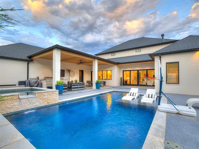 15825 Lacebark Ln, Edmond, OK 73013 - pool at dusk with an in-ground hot tub, an outdoor living space, an outdoor pool, and a patio