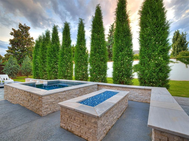 15825 Lacebark Ln, Edmond, OK 73013 - pool at dusk with a fire pit, an in-ground hot tub, and a patio area
