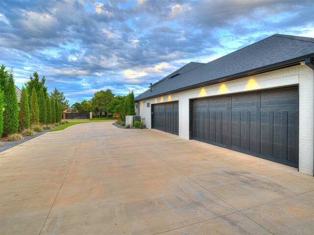 15825 Lacebark Ln, Edmond, OK 73013 - garage featuring concrete driveway and central AC unit