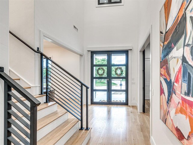 15825 Lacebark Ln, Edmond, OK 73013 - foyer entrance with wood finished floors, stairway, a high ceiling, and baseboards
