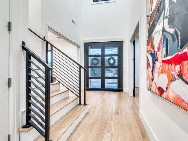 15825 Lacebark Ln, Edmond, OK 73013 - foyer entrance featuring wood finished floors, stairs, baseboards, and a towering ceiling