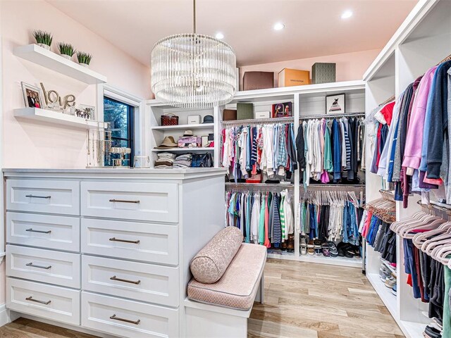 15825 Lacebark Ln, Edmond, OK 73013 - spacious closet featuring a chandelier and light wood finished floors