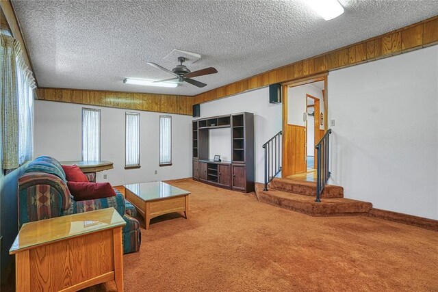 1909 N Flamingo Ln, Altus, OK 73521 - living area with carpet floors, a textured ceiling, ceiling fan, and stairs