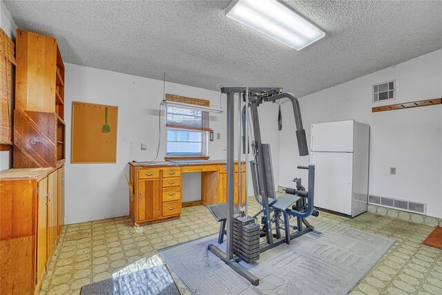 1909 N Flamingo Ln, Altus, OK 73521 - exercise area with light floors and a textured ceiling