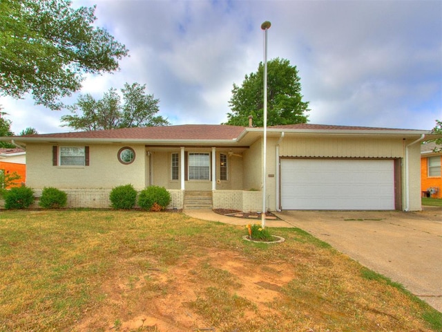 1505 W Blake St, El Reno, OK 73036 - single story home with brick siding, a garage, concrete driveway, and a front yard
