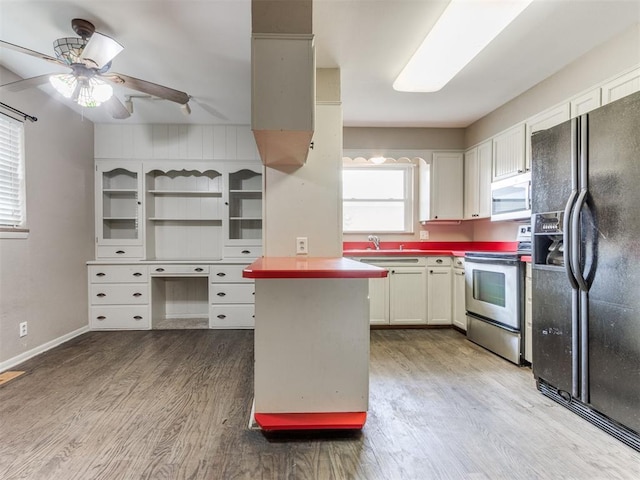 1505 W Blake St, El Reno, OK 73036 - kitchen featuring appliances with stainless steel finishes, wood finished floors, a ceiling fan, open shelves, and white cabinetry