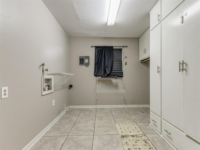 1505 W Blake St, El Reno, OK 73036 - laundry area with cabinet space, washer hookup, baseboards, and light tile patterned flooring