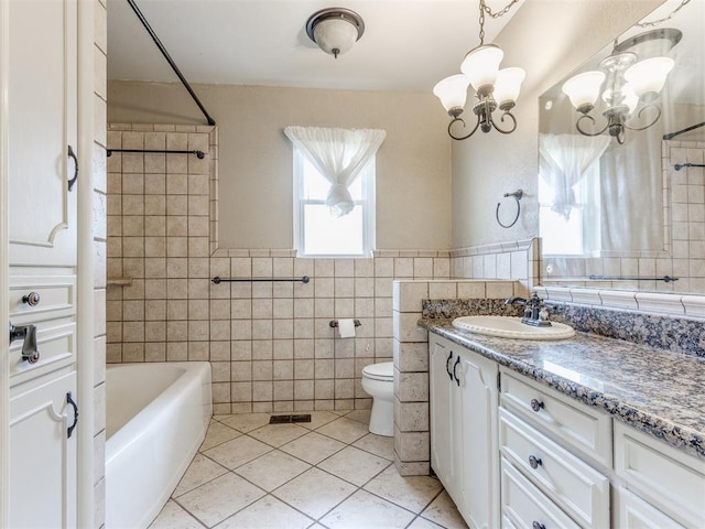 1505 W Blake St, El Reno, OK 73036 - bathroom with vanity, tile walls, a chandelier, tile patterned flooring, and toilet