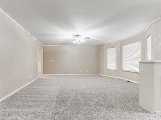 1505 W Blake St, El Reno, OK 73036 - spare room featuring ornamental molding, ceiling fan, carpet flooring, and baseboards