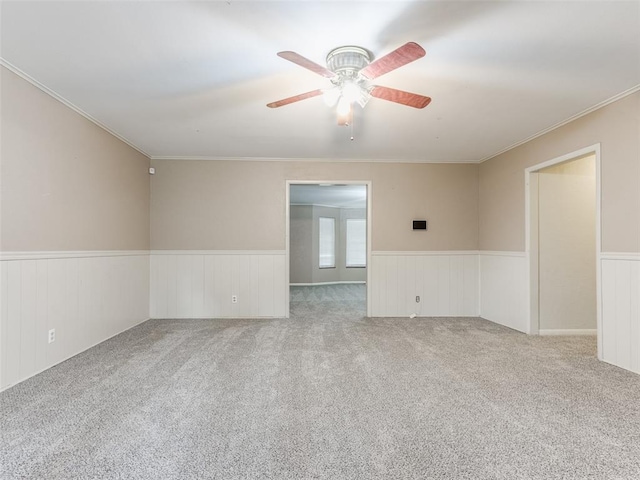 1505 W Blake St, El Reno, OK 73036 - empty room featuring wainscoting, a ceiling fan, crown molding, and carpet