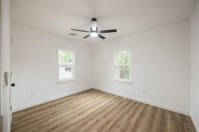 2817 N Donnelly Ave, Oklahoma City, OK 73107 - empty room with wood finished floors, ceiling fan, and baseboards