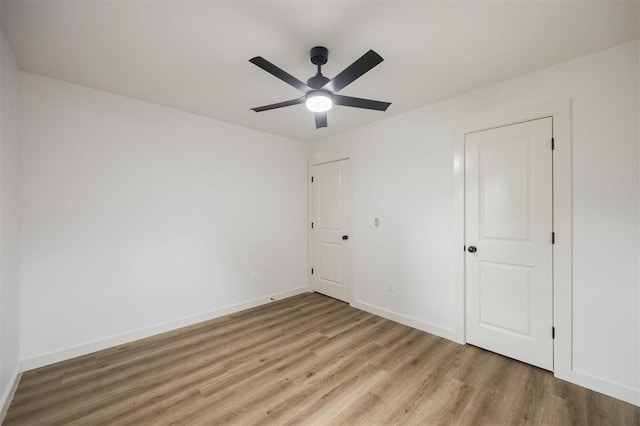 2817 N Donnelly Ave, Oklahoma City, OK 73107 - unfurnished bedroom with light wood-style floors, baseboards, and ceiling fan