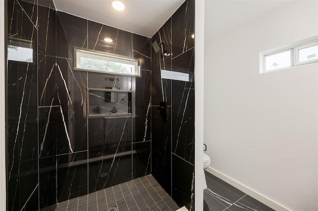 2817 N Donnelly Ave, Oklahoma City, OK 73107 - bathroom with a marble finish shower, toilet, healthy amount of natural light, baseboards, and recessed lighting