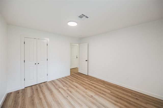 2817 N Donnelly Ave, Oklahoma City, OK 73107 - unfurnished bedroom with wood finished floors, baseboards, and a closet