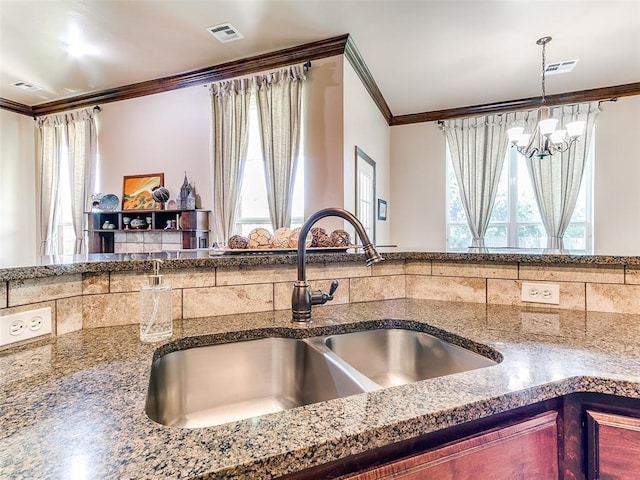 12275 Autumn Brk, Guthrie, OK 73044 - kitchen featuring a sink, crown molding, healthy amount of natural light, a chandelier, and dark stone counters