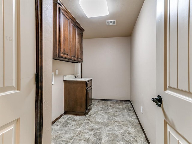 12275 Autumn Brk, Guthrie, OK 73044 - laundry area featuring light stone finish flooring and baseboards