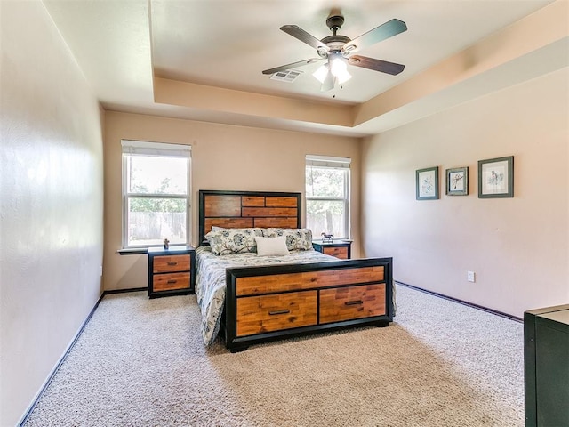 12275 Autumn Brk, Guthrie, OK 73044 - bedroom featuring light colored carpet, a raised ceiling, baseboards, and ceiling fan