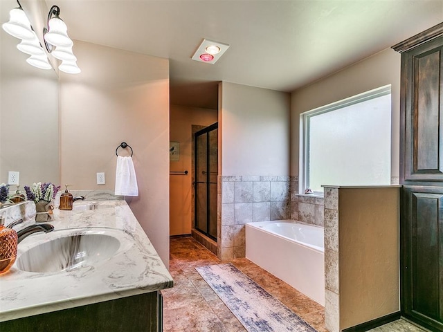 12275 Autumn Brk, Guthrie, OK 73044 - bathroom featuring a garden tub, a stall shower, double vanity, a chandelier, and tile patterned floors