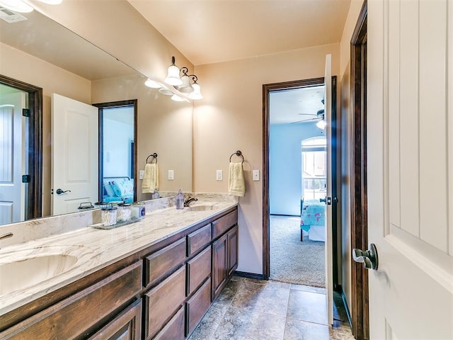 12275 Autumn Brk, Guthrie, OK 73044 - bathroom featuring double vanity, baseboards, and connected bathroom