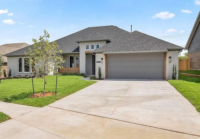 3921 Bandera Trl, Norman, OK 73071 - view of front of house featuring a front yard, a shingled roof, driveway, a garage, and stucco siding