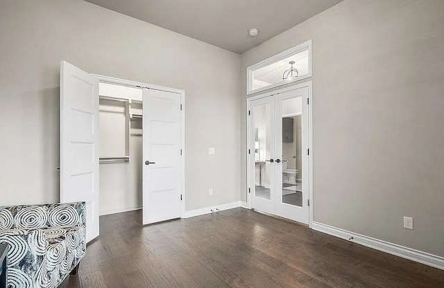 3921 Bandera Trl, Norman, OK 73071 - unfurnished bedroom with french doors, dark wood-type flooring, baseboards, and a closet