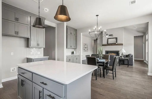 3921 Bandera Trl, Norman, OK 73071 - kitchen featuring gray cabinetry, baseboards, a chandelier, dark wood-style floors, and light countertops