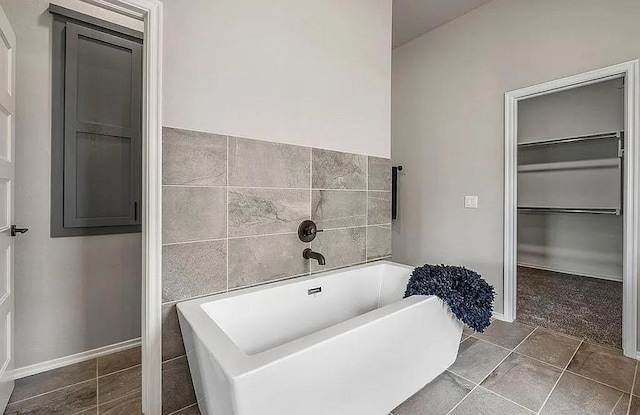 3921 Bandera Trl, Norman, OK 73071 - full bath featuring a freestanding tub, tile walls, tile patterned floors, and baseboards