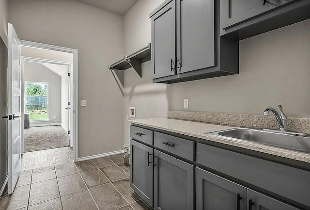 3921 Bandera Trl, Norman, OK 73071 - laundry area featuring washer hookup, cabinet space, baseboards, and dark tile patterned floors