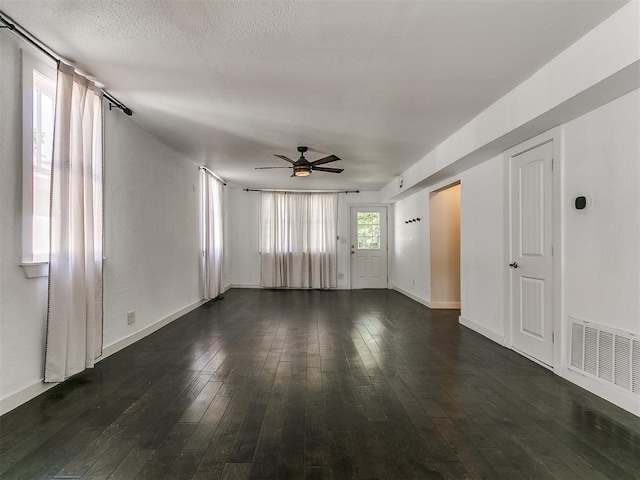 121 NW 27th St, Oklahoma City, OK 73103 - unfurnished room featuring ceiling fan, dark wood-style flooring, and baseboards