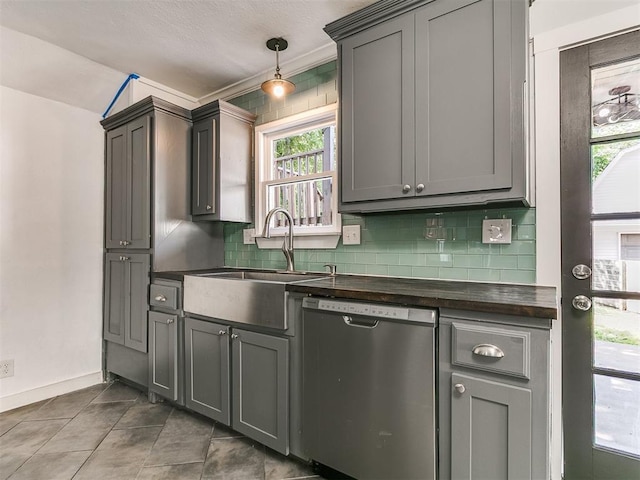121 NW 27th St, Oklahoma City, OK 73103 - kitchen with stainless steel dishwasher, dark countertops, decorative backsplash, a sink, and gray cabinets
