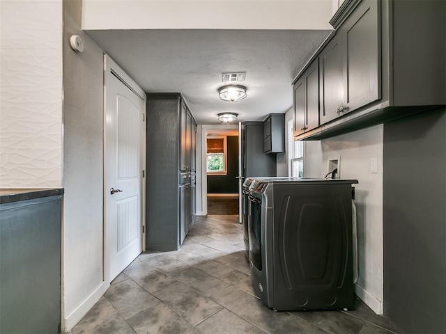 121 NW 27th St, Oklahoma City, OK 73103 - laundry room with cabinet space, separate washer and dryer, and baseboards