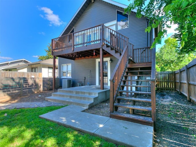 121 NW 27th St, Oklahoma City, OK 73103 - back of house with a deck, a fenced backyard, and stairs