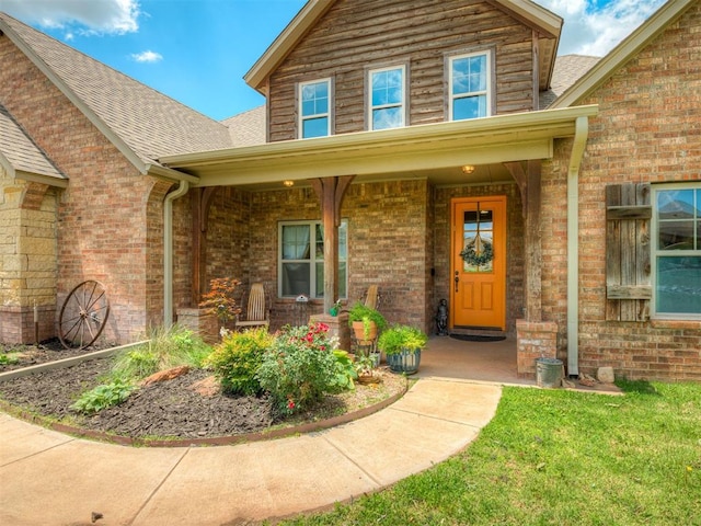 13505 Shady Pine Cir, Edmond, OK 73025 - doorway to property with a porch, brick siding, and roof with shingles