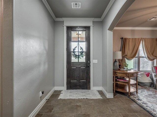13505 Shady Pine Cir, Edmond, OK 73025 - foyer featuring baseboards, ornamental molding, and dark stone finish floors