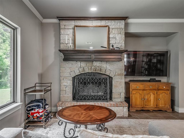 13505 Shady Pine Cir, Edmond, OK 73025 - living area featuring crown molding, baseboards, and a stone fireplace