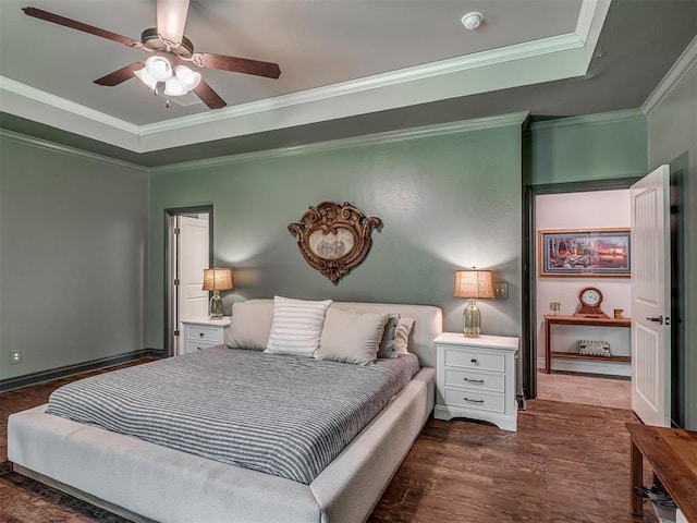 13505 Shady Pine Cir, Edmond, OK 73025 - bedroom featuring ornamental molding, wood finished floors, a raised ceiling, and a ceiling fan
