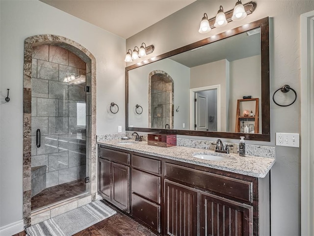 13505 Shady Pine Cir, Edmond, OK 73025 - full bathroom with double vanity, a stall shower, and wood finished floors