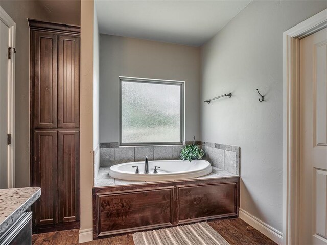 13505 Shady Pine Cir, Edmond, OK 73025 - full bath with a garden tub, wood finished floors, and vanity