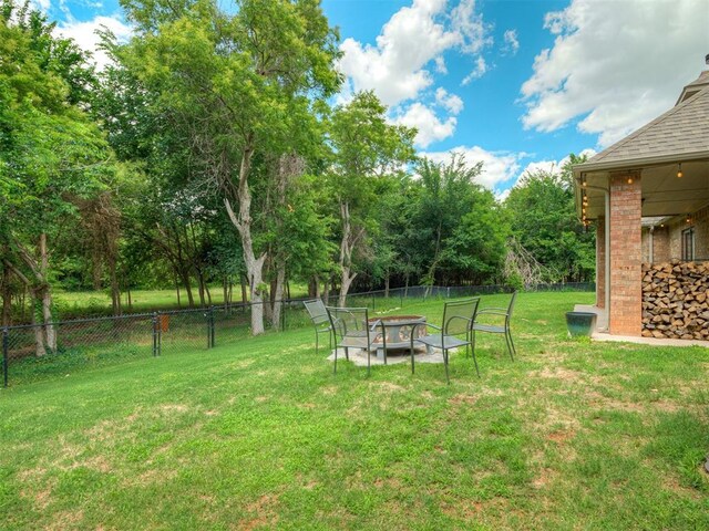 13505 Shady Pine Cir, Edmond, OK 73025 - view of yard featuring an outdoor fire pit and view of wooded area