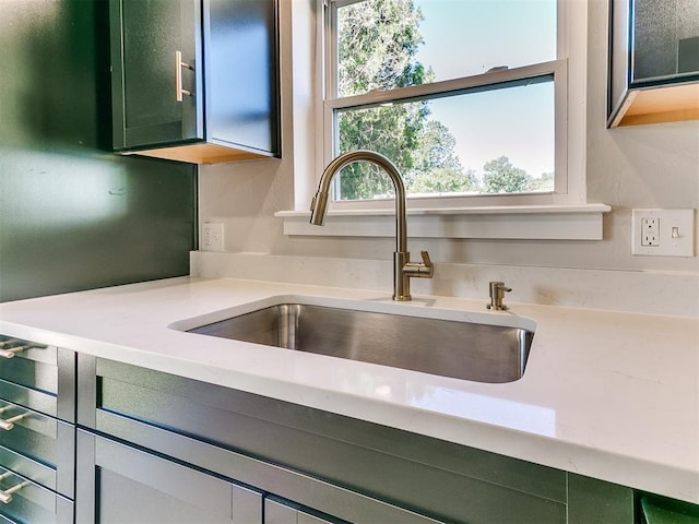 7624 NW 14th Ter, Oklahoma City, OK 73127 - kitchen view of a sink, light countertops, and green cabinetry
