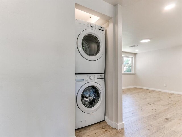 7624 NW 14th Ter, Oklahoma City, OK 73127 - laundry area with estacked washer and dryer, baseboards, and light wood-style flooring