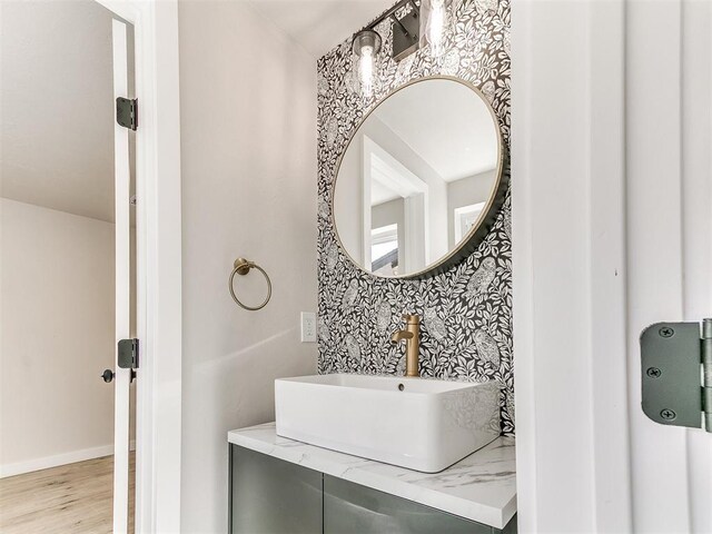 7624 NW 14th Ter, Oklahoma City, OK 73127 - bathroom featuring wood finished floors, baseboards, and vanity