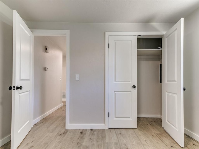 7624 NW 14th Ter, Oklahoma City, OK 73127 - unfurnished bedroom with light wood finished floors, baseboards, and a closet