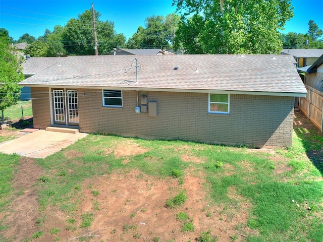 7624 NW 14th Ter, Oklahoma City, OK 73127 - back of property with brick siding, a patio area, and roof with shingles