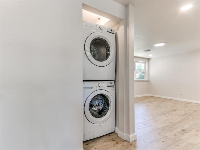 7624 NW 14th Ter, Oklahoma City, OK 73127 - laundry room featuring stacked washing machine and dryer and light wood-type flooring